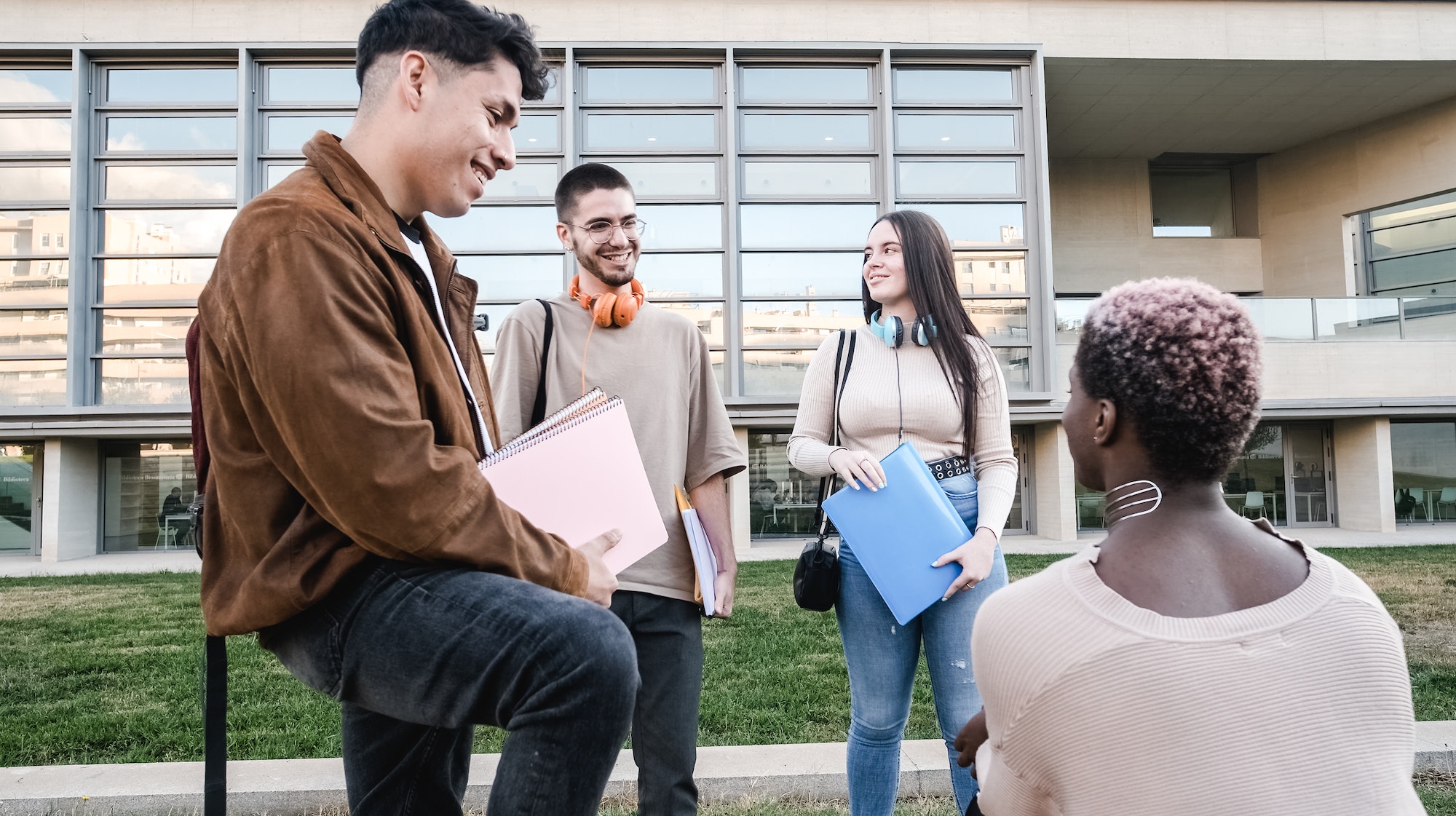 Group of students in a circle talking outside the university